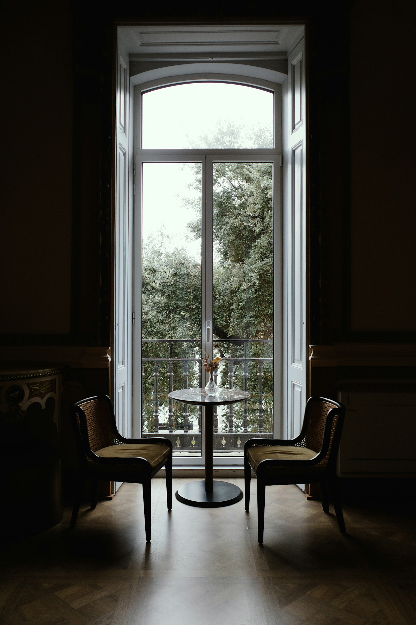 Two chairs and a small table by a window